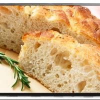 Sliced focaccia with a sprig of rosemary